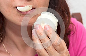 Close up with the mouth of a woman eating onion