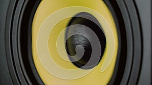 Close up at moving sub-woofer. Speaker part. Black and yellow colors. UHD video