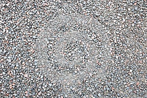 Close up of muddy puddle with small stones on wet surface. Background texture with top view