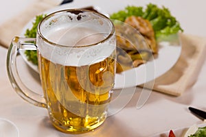 Close up Mug of Beer Beside Main Dish