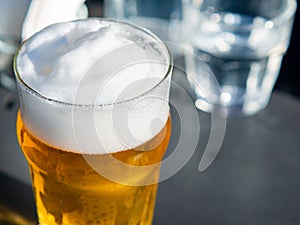 close up mug of lager beer with high froth