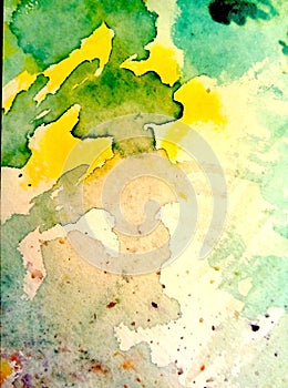 Close-up of multi-colored watercolor stains on paper. Yellow, green, blue, brown blots, drips, drops.