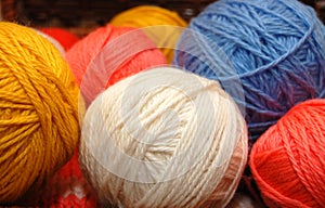 Close up on multi-coloured balls of wool