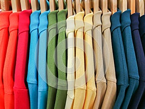 Close up Multicolor Shirts are hanging on Clothes Hanger