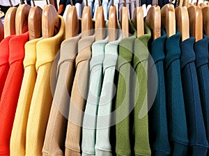 Close up Multicolor Shirts are hanging on Clothes Hanger