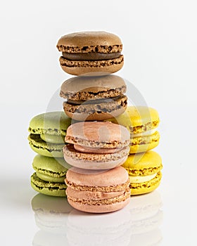 Close up multicolored macarons lined up on a white background. Typical french sweet