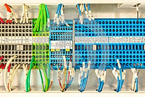 Close up of multicolored wiring connectors or terminal block for industrial electronic with marked cable wires.