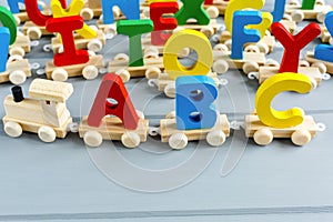 Close up Multicolored wooden letters with ABC on gray background. Set of toys for studying alphabet. Education, back to school