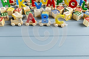 Close up Multicolored wooden letters with ABC on gray background. Set of toys for studying alphabet. Education, back to school