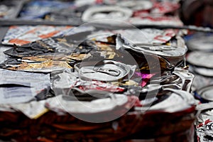 Close up of multiple flattered cans in a recycling plant