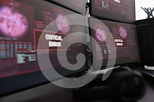 Close up of multiple monitors having critical error message on display
