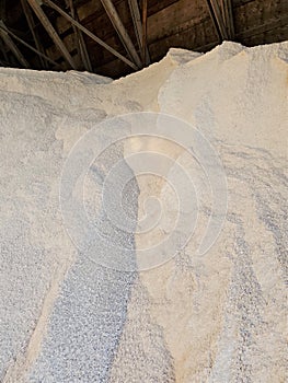 Close up of municipal salt pile in wooden shed