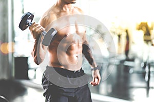 Close Up muscular on hand of young  bodybuilder man lifting weights in Fitness gym. Lifestye Healthy gym, sport, training, athlete photo
