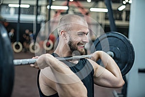 Close up of muscular man at a crossfit gym lifting a barbell