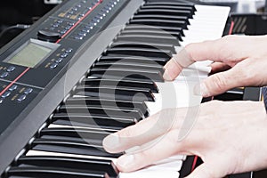 Close-up of a music performer`s hand playing the piano, man`s hand, classical music, keyboard, synthesizer, pianist.