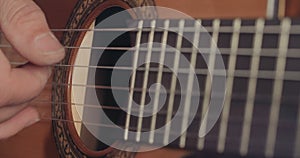 Close up of a Musician playing acoustic guitar in a recording studio