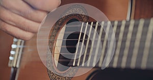 Close up of a Musician playing acoustic guitar in a recording studio