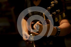 Close up musician playing electric guitar