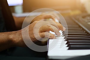 A close up of a musician playing the piano With vintage filters Music learning