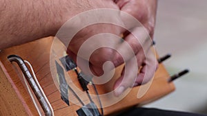 Close-up of a musician`s hands playing the harp.