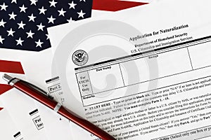 Close-up of n-400 form. application for naturalization topview, on a background of United States flag
