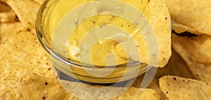 Close-up nachos corn chips in cheese sauce with selective focus, horizontal banner