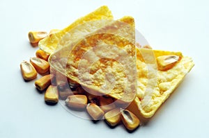 Close up on nachos with corn kernels.