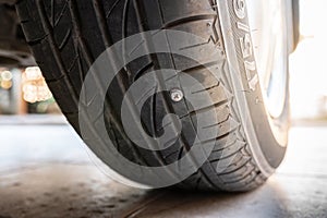 Close-up nail or screw stick on the car tire