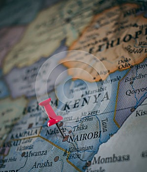 Close up of Nairobi pin pointed on the world map with a pink pushpin