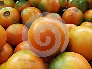 Close-up of a naranjilla or lulo fruit. Exotic, tropical and citrus produce.