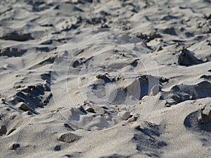 Close up of natural looking uneven sandy ground on the beach