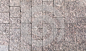 Decorative facing, made of a scabrous gray granite plates with a natural ornament.