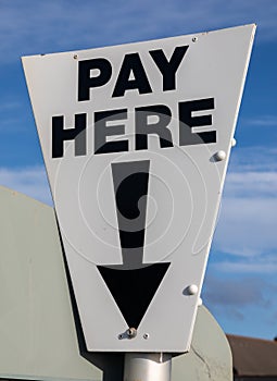 Close-up of a near triangular black and white pay here sign at a cark park St Annes on Sea Fylde Coast February 2019
