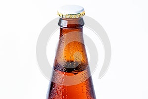 Close-up of the neck of a wet glass bottle of dark beer with a cork on a white background. Alcoholic beverages