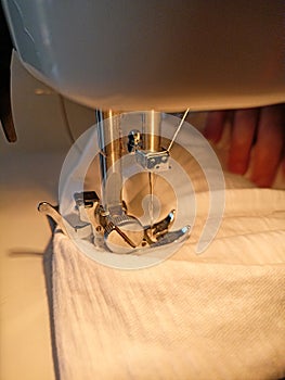 Close-up of the needle and presser foot of a sewing machine