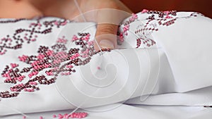 Close-Up Of Needle And Thread, Embroider Patterns With Beads. Handmade sewing wedding dress.