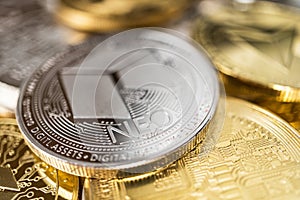 Close-up of neo physical coin on stack of many other cryptocurrencies