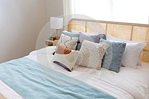 New bed comfort with decorative pillows ,headboard and side table lamp.