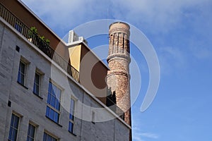 Close up of new building grey facade with windows in Noblessner new district in Tallinn, Estonia, Europe. Old tower on