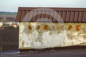 Close-up of a new built chimney on a house roof under construction. Unfinished building, repair and renovation work.