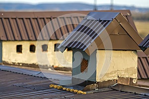 Close-up of a new built chimney on a house roof under construction. Unfinished building, repair and renovation work.