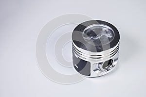 Close-up of the new internal combustion engine piston on a gray gradient background. The concept of new spare parts of