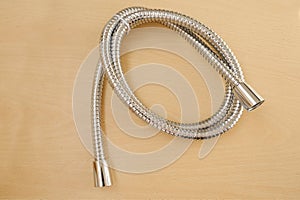 close-up new metal stainless steel shower hose with double linkage, anti-twist, concept hygienic shower, locksmith work photo