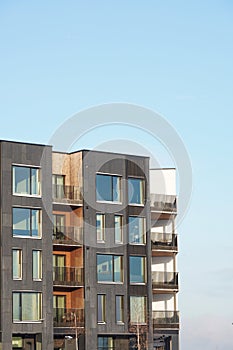 Close up of new modern apartments building at Kalamaja district during sunny day. Tallinn, Estonia, Europe. January 2024