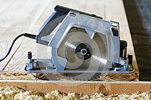 Close-up of new modern powerful circular electrical saw cutting