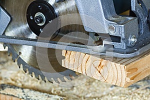 Close-up of new modern powerful circular electrical saw cutting