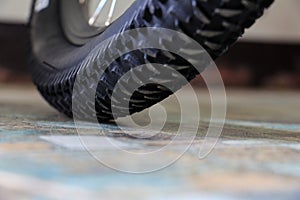 Close-up of new mountain bike tire tread on the ground.