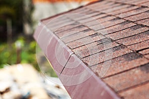 Close up of new roof with asphalt shingles.