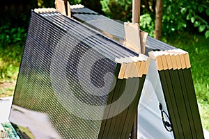 Close-up new solar panels with protective cardboard corners ready for installation.