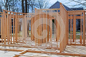Close-up new stick built home under construction under blue sky Framing structure wood frame of wooden houses home.
